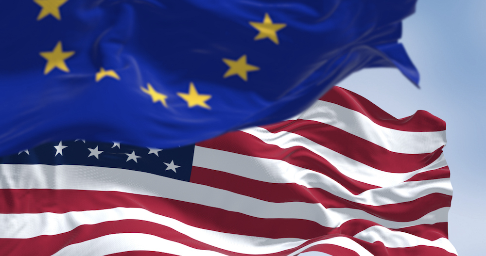 The flags of the United States of America and the European Union waving in the wind on a clear day. 3D illustration render. Rippled fabric. Selective focus. International politics, alliance